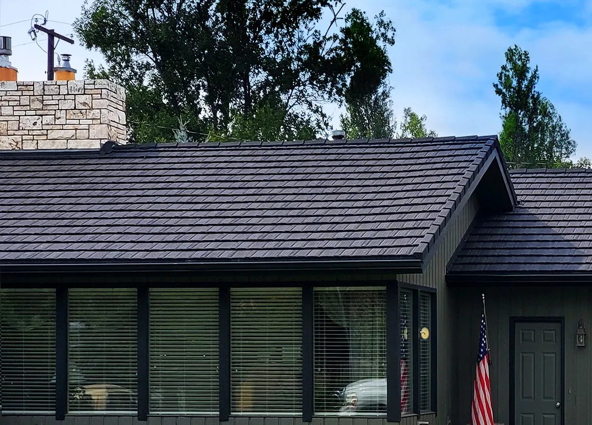 Close-up of a charcoal WeatherLok stone-coated steel shake roof on a home
