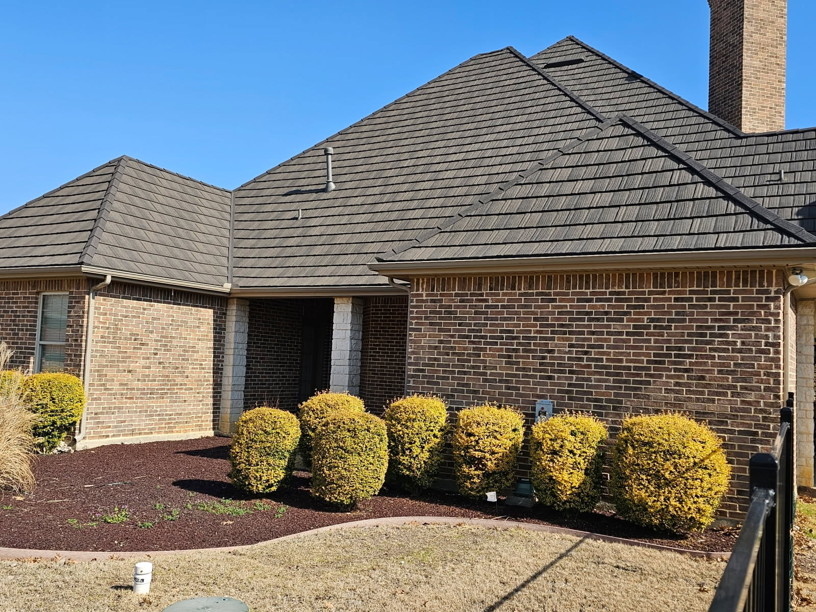 Brick home with a WeatherLok stone-coated steel shake roof
