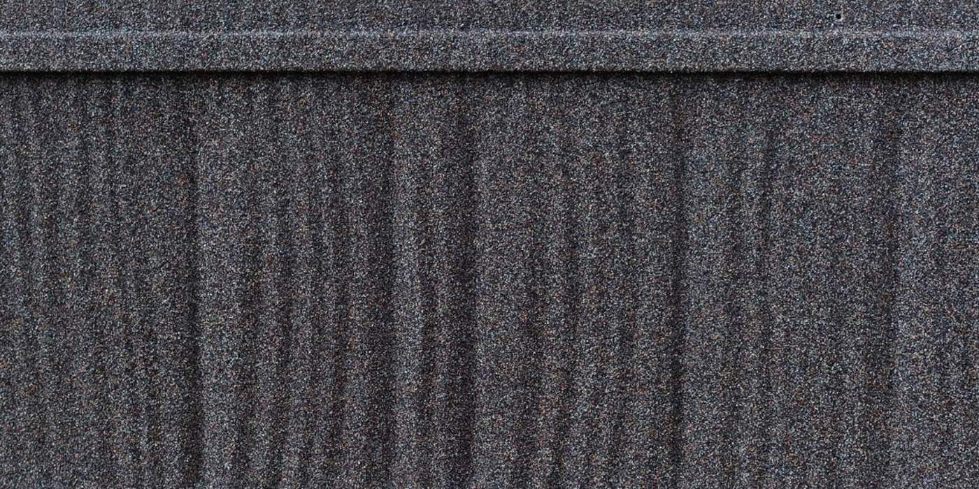 A WeatherLok Charcoal Shake panel up close, stone-coated steel with hand-split wood grain