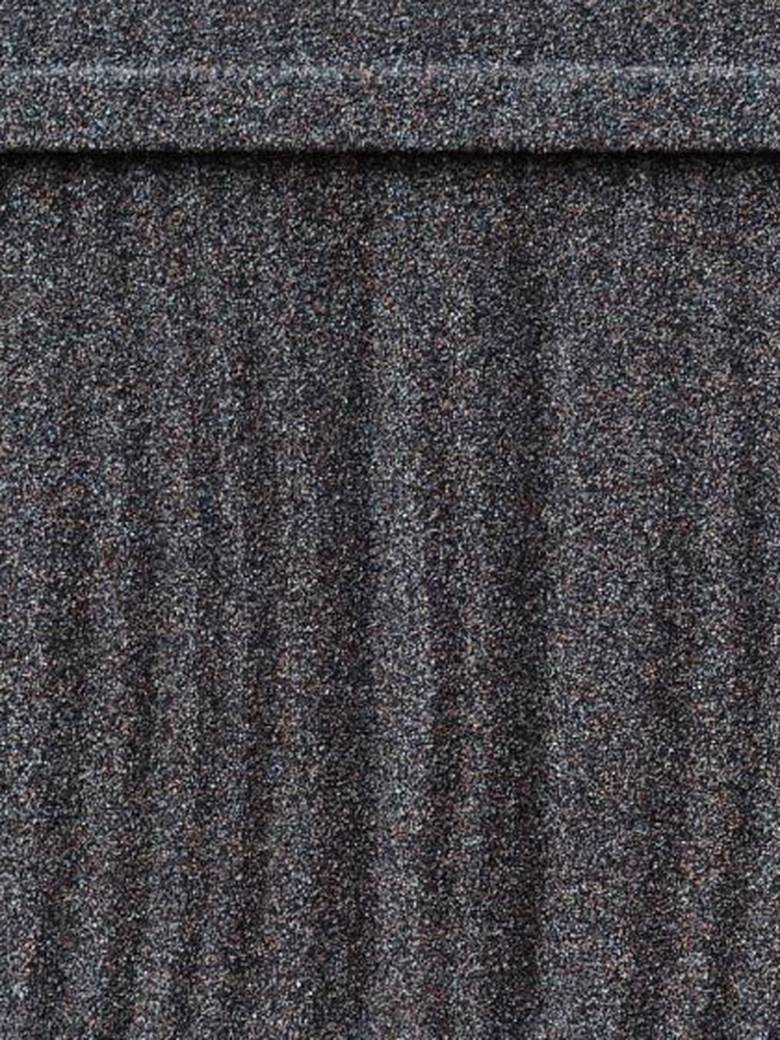 Close-up of the WeatherLok shake profile, showing the stone granule surface, the vertical grain striations that run down the slope, and the thick butt edge of the course above.