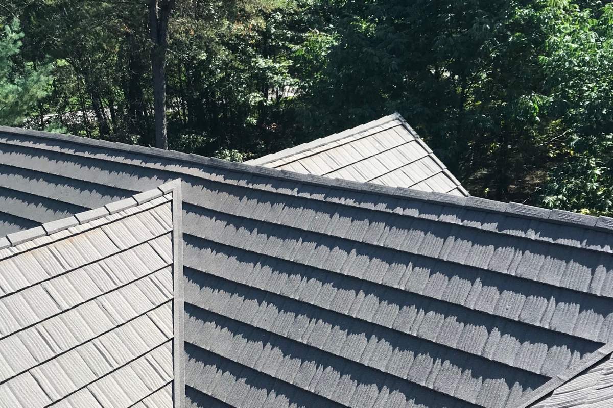 A Weatherwood Shake roof over multiple planes and dormers, stone-coated steel