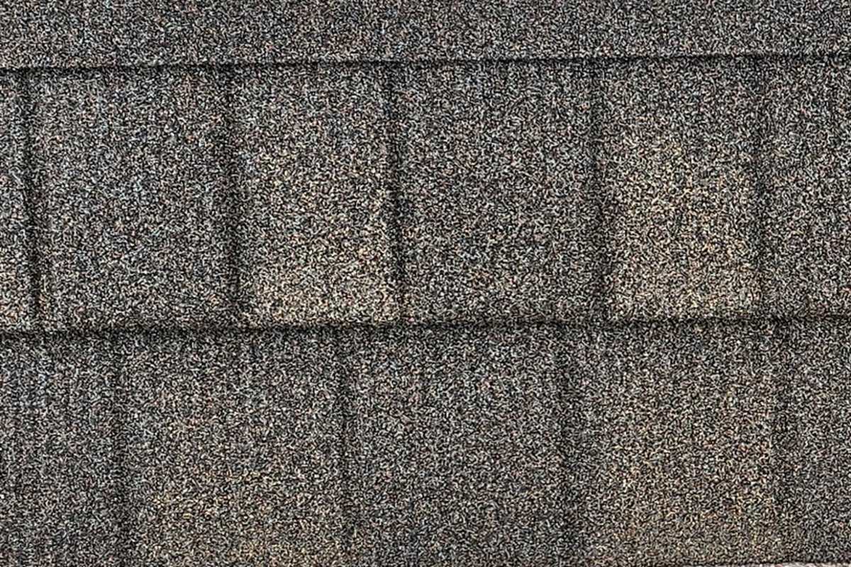 A WeatherLok Weatherwood Slate Shingle panel up close, stone-coated steel